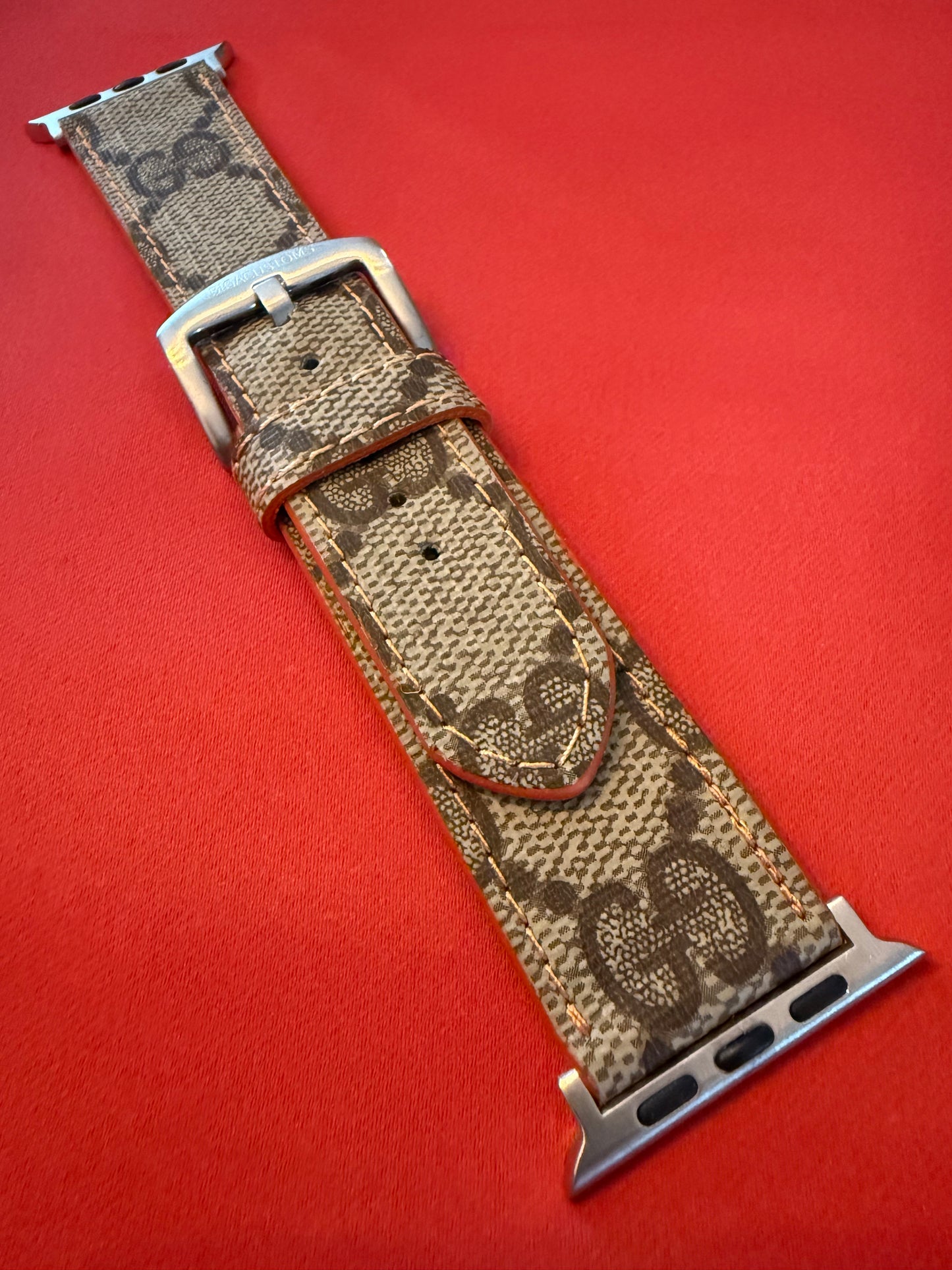 Custom Apple Watch strap with orange π stitching and edge.
